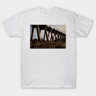 Lighthouse through the wooden pier T-Shirt